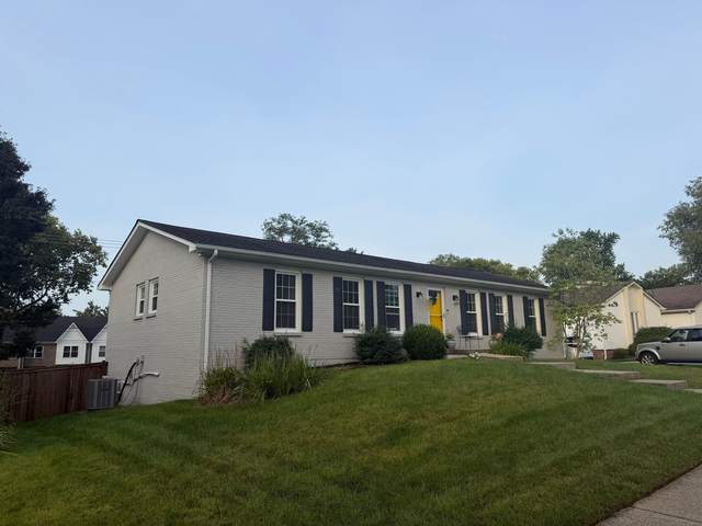 Before: painted-brick ranch with a yellow front door and its old roof