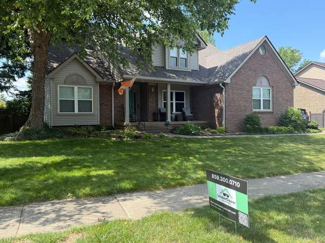 After: the same home with a new roof and an UNDERCOVER yard sign