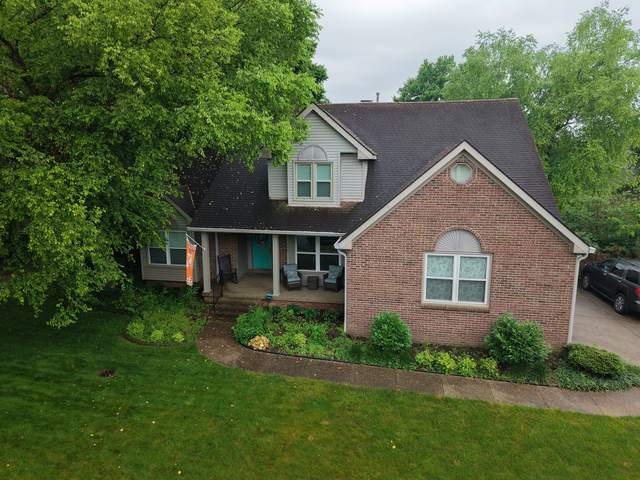 Before: brick one-and-a-half-story home with its old roof